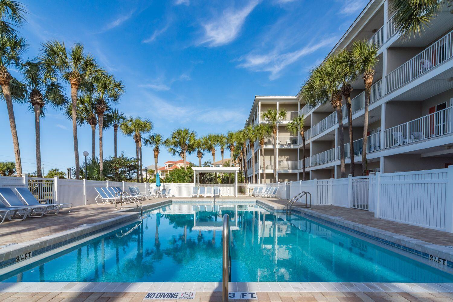 95 Laura Hamilton Boulevard, Unit 209 Santa Rosa Beach, FL 32459 - Photo 27 of 37 a swimming pool with outdoor seating and yard