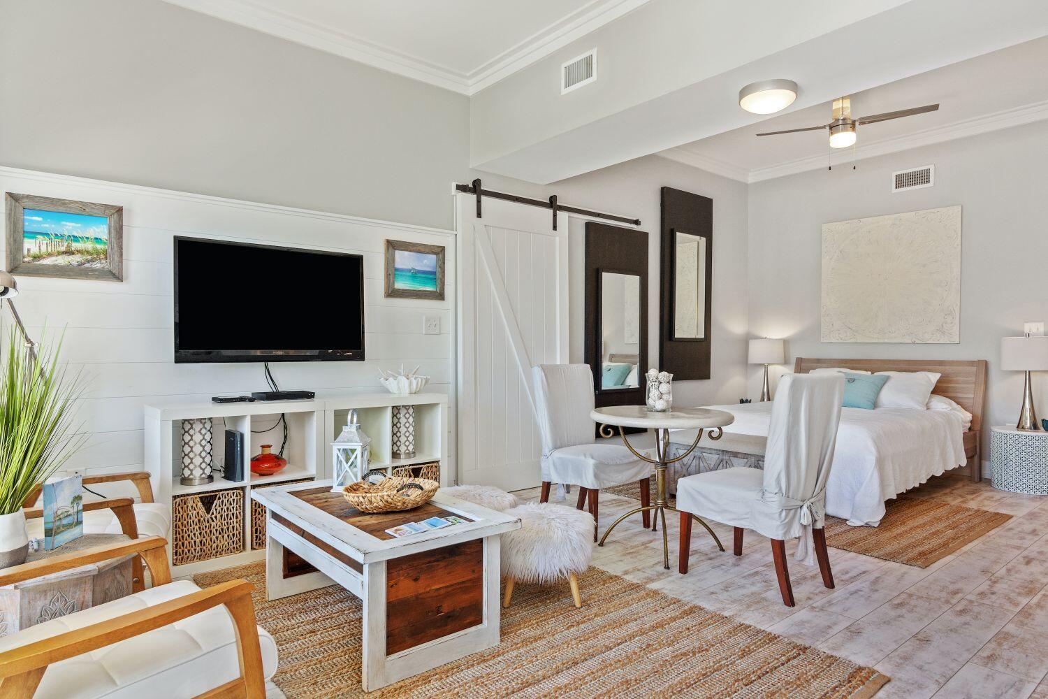 95 Laura Hamilton Boulevard, Unit 209 Santa Rosa Beach, FL 32459 - Photo 4 of 37 a living room with furniture and a flat screen tv