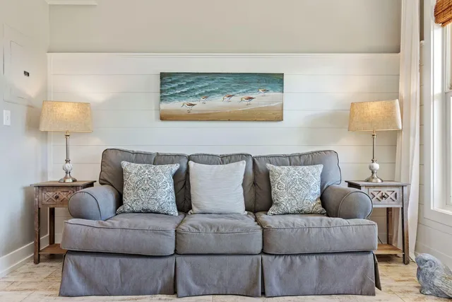 a living room with furniture and a lamp