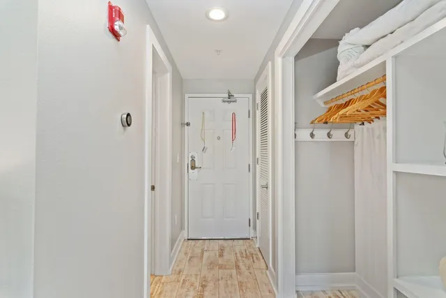 a view of a hallway with wooden floor and entryway