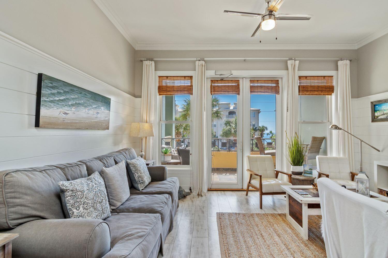 95 Laura Hamilton Boulevard, Unit 209 Santa Rosa Beach, FL 32459 - Photo 10 of 37 a living room with furniture a large window and wooden floor