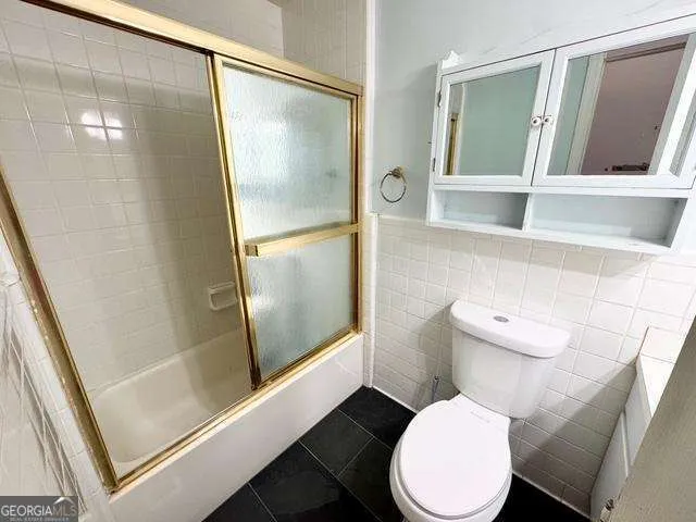 a white toilet sitting next to a bathroom sink