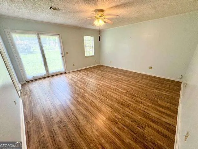 wooden floor in an empty room with a window