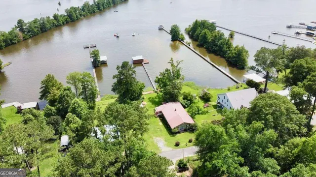 an aerial view of a house with outdoor space and lake view