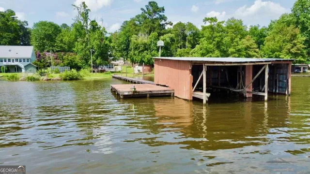 a view of a ocean with boats and trees in the background