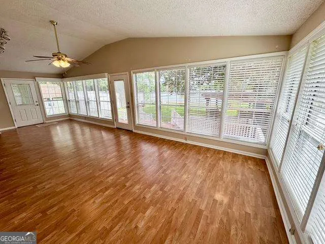 wooden floor in an empty room with a window