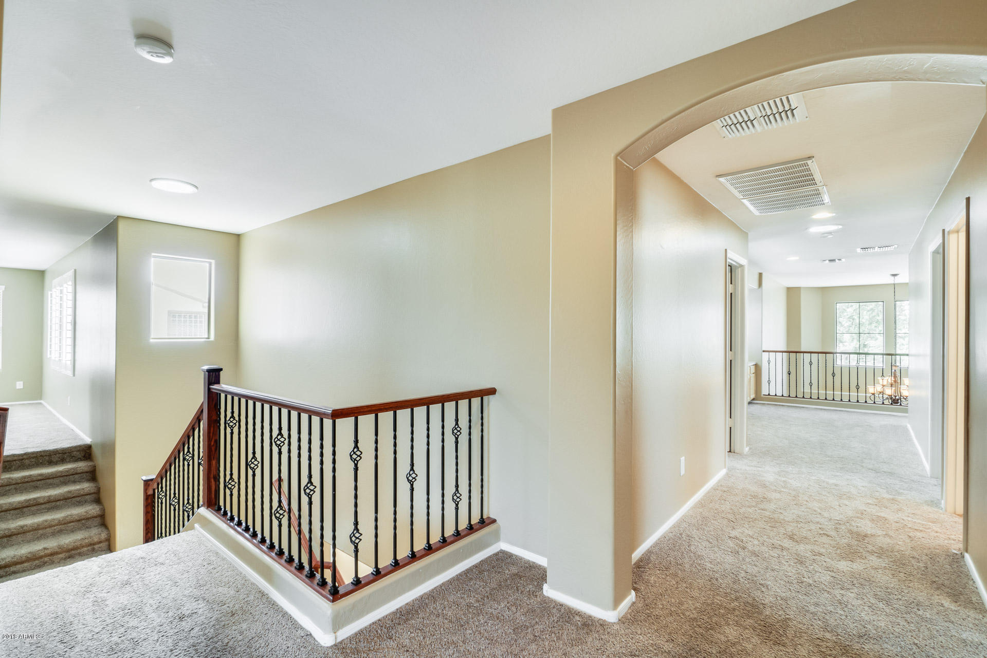 3250 East Blue Ridge Way Gilbert, AZ 85298 - Photo 28 of 44 a view of a hallway with a chandelier and a bathroom