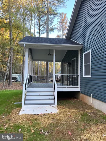 a kitchen that has a sink a stove and a wooden floor