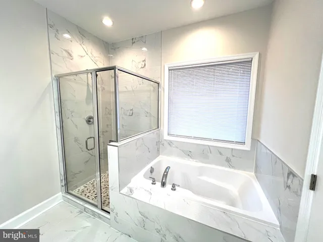 a bathroom with a granite countertop sink a toilet and bathtub