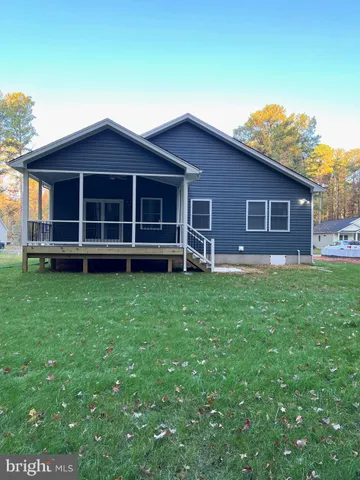 a view of a house with a yard and sitting area