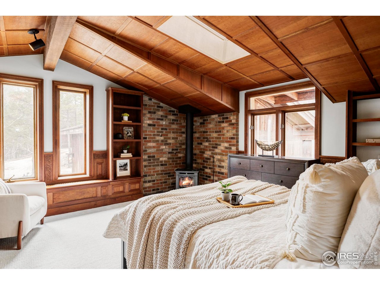 279 Forrest Lane Boulder, CO 80302 - Photo 11 of 36 a bedroom with a bed and glass windows