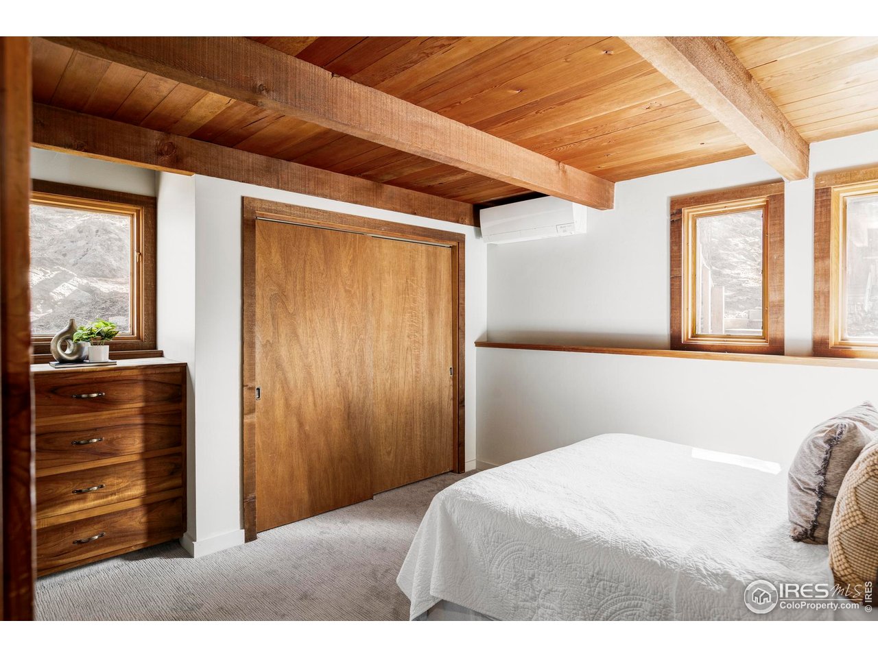 279 Forrest Lane Boulder, CO 80302 - Photo 17 of 36 a bedroom with a bed and a dresser