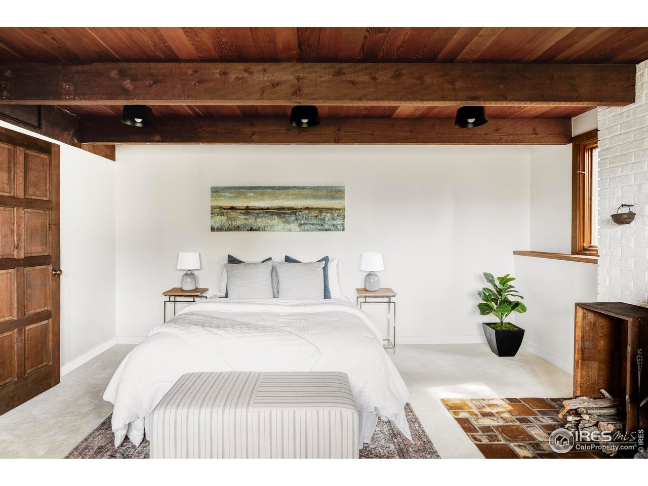 279 Forrest Lane Boulder, CO 80302 - Photo 22 of 36 a bedroom with a bed and a potted plant