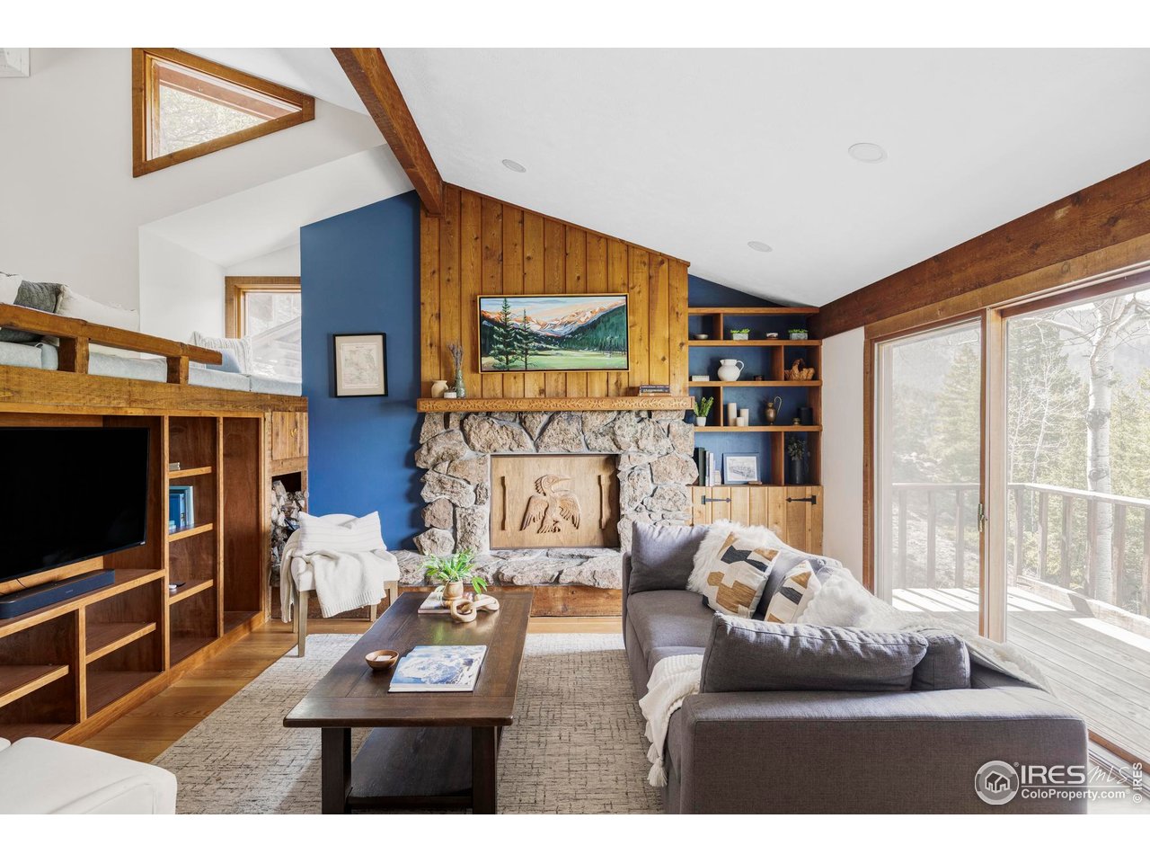 279 Forrest Lane Boulder, CO 80302 - Photo 4 of 36 a living room with furniture a flat screen tv and a floor to ceiling window