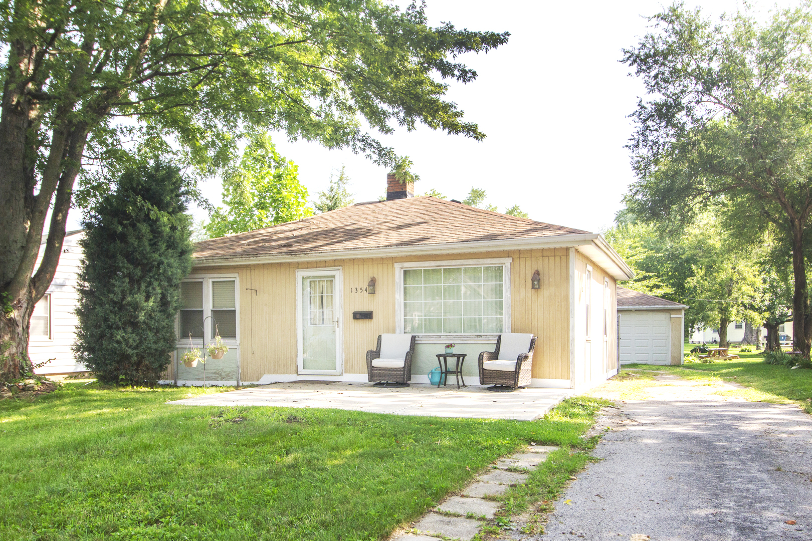 a front view of house with yard patio and green space
