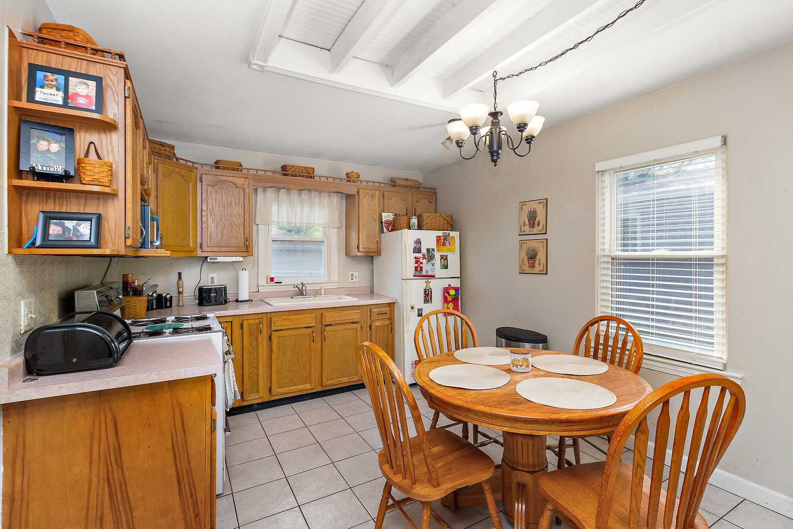 1354 Circle Drive Kankakee, IL 60901 - Photo 2 of 14 a kitchen with stainless steel appliances granite countertop a sink a stove a dining table and chairs