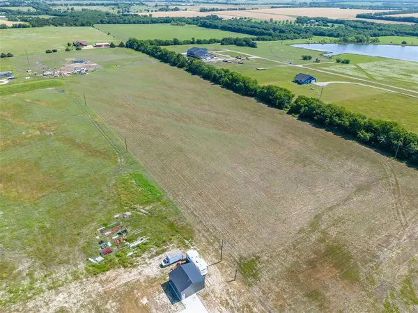 a view of a field with an ocean view