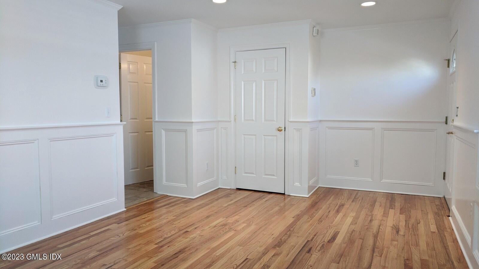 66 Ute Place, Unit A Greenwich, CT 06830 - Photo 9 of 18 an empty room with wooden floor