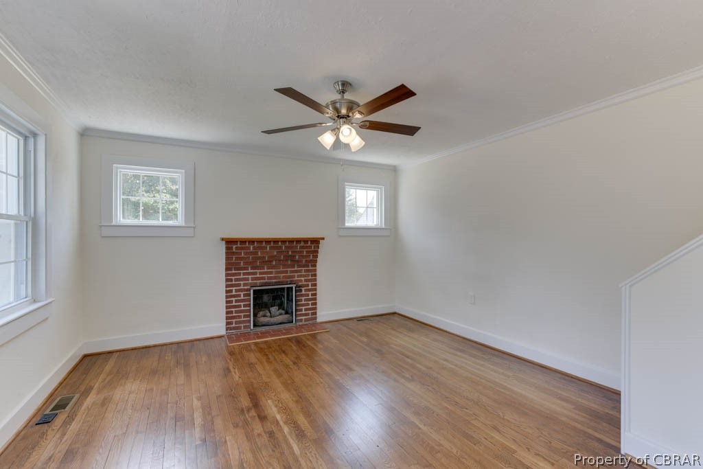 400 Showalter Road Yorktown, VA 23692 - Photo 8 of 49 Unfurnished living room with a fireplace, a wealth of natural light, and wood-type flooring