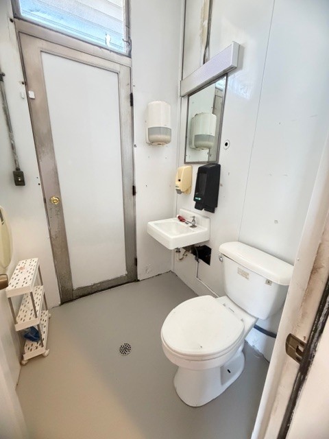 1000 East Main Street Decherd, TN 37324 - Photo 11 of 18 a white toilet sitting next to a bathroom sink