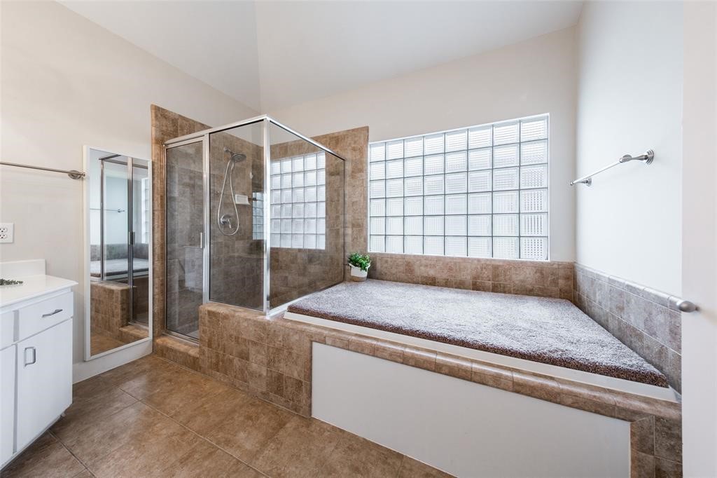 3027 Buttercup Street Houston, TX 77063 - Photo 12 of 29 a bedroom with a bed and a dresser next to a window