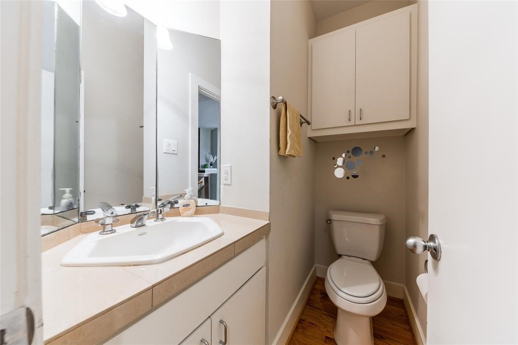 3027 Buttercup Street Houston, TX 77063 - Photo 8 of 29 a bathroom with a toilet sink and mirror