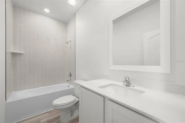 a view of a house with a big yard potted plants and large tree