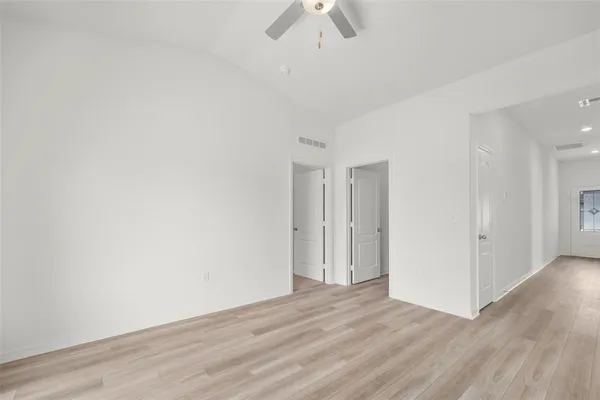 a view of room with hardwood floor and ceiling fan