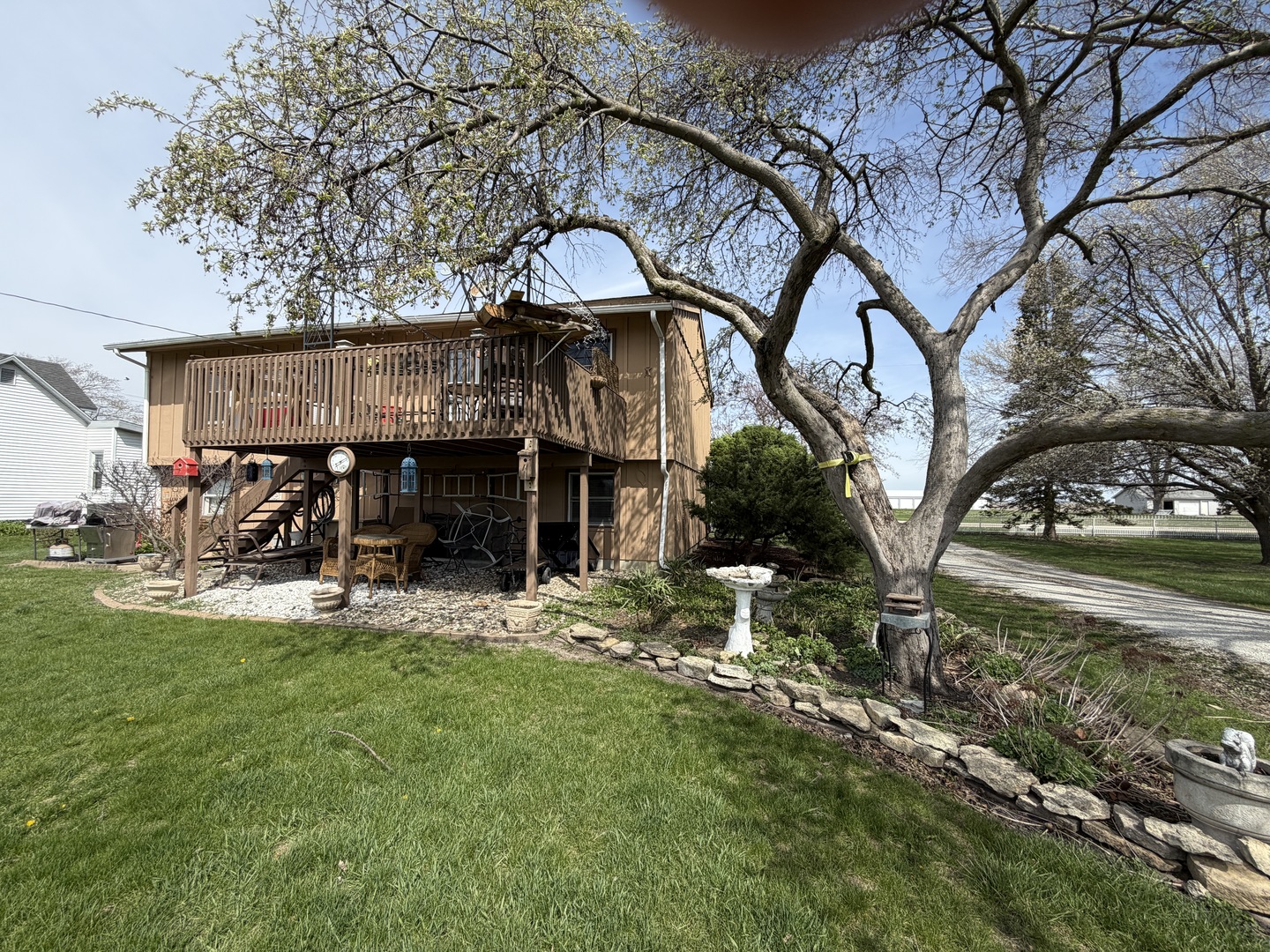 101 1/2 East North Street Danforth, IL 60930 - Photo 13 of 14 a view of a house with a yard chairs and table in the patio