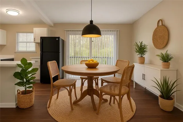 a dining room with furniture and wooden floor