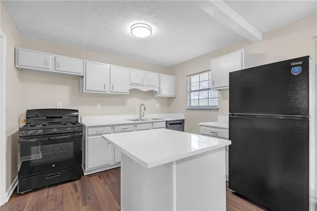 a kitchen with a refrigerator stove and sink