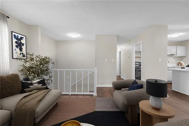 a living room with furniture and a potted plant