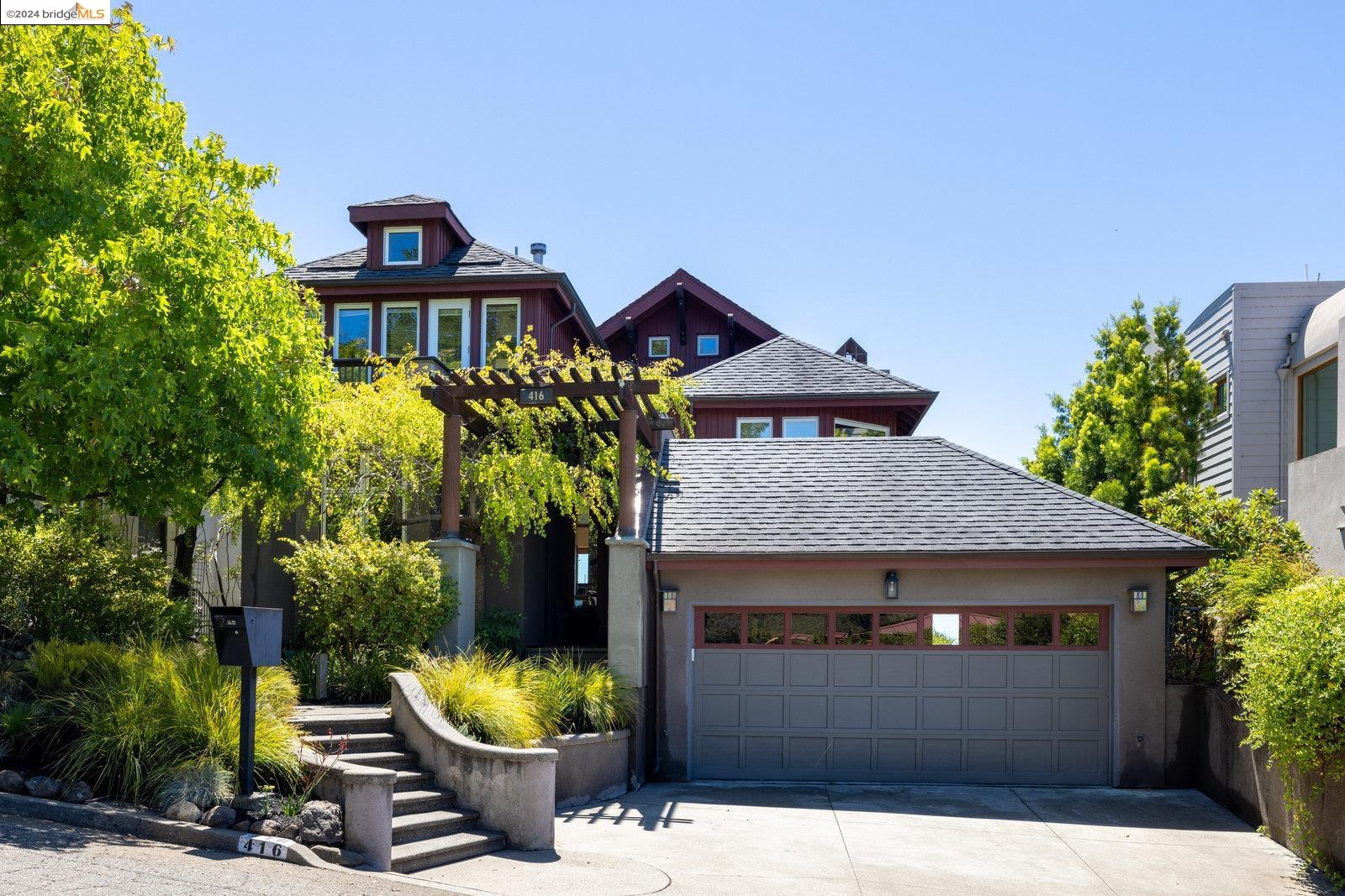 a front view of a house with yard and sitting area