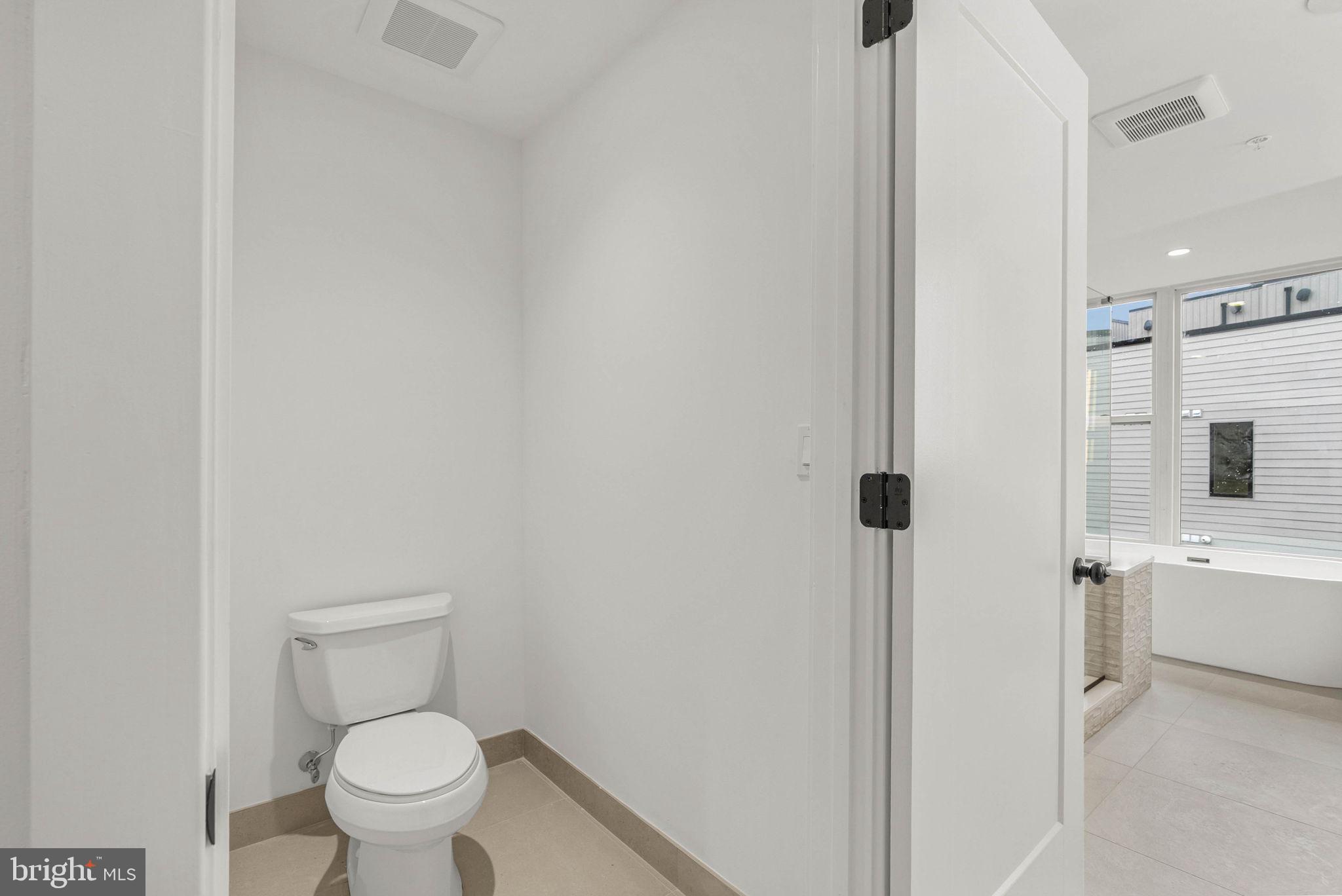 650 Fairmount Avenue, Unit A2 Philadelphia, PA 19123 - Photo 15 of 40 a white toilet sitting next to a bathroom sink