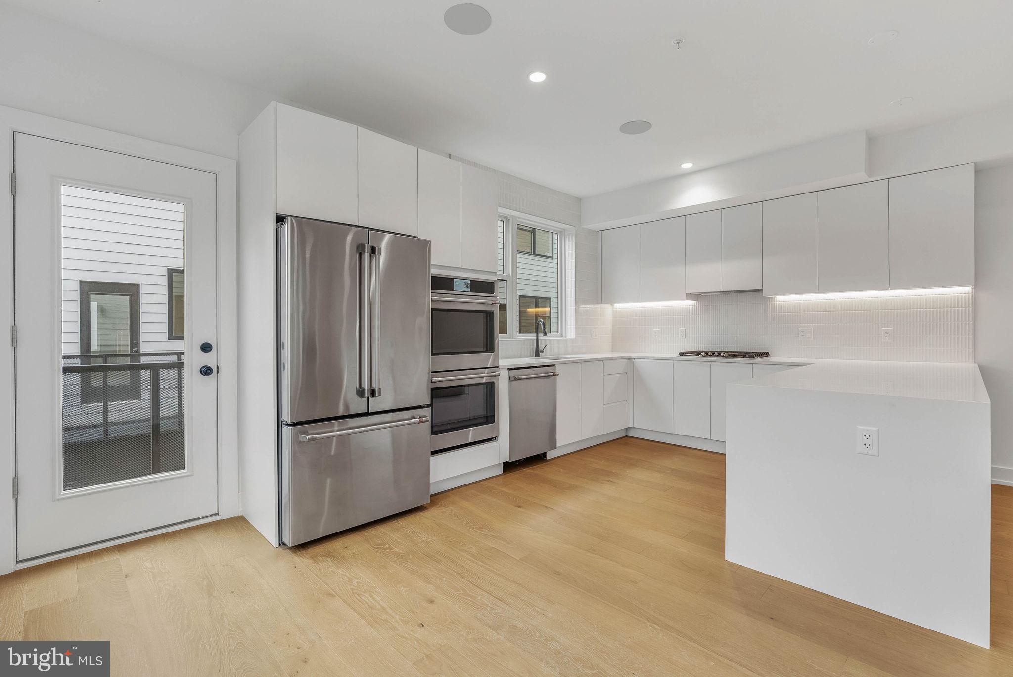 650 Fairmount Avenue, Unit A2 Philadelphia, PA 19123 - Photo 2 of 40 a kitchen with stainless steel appliances a refrigerator and a stove top oven