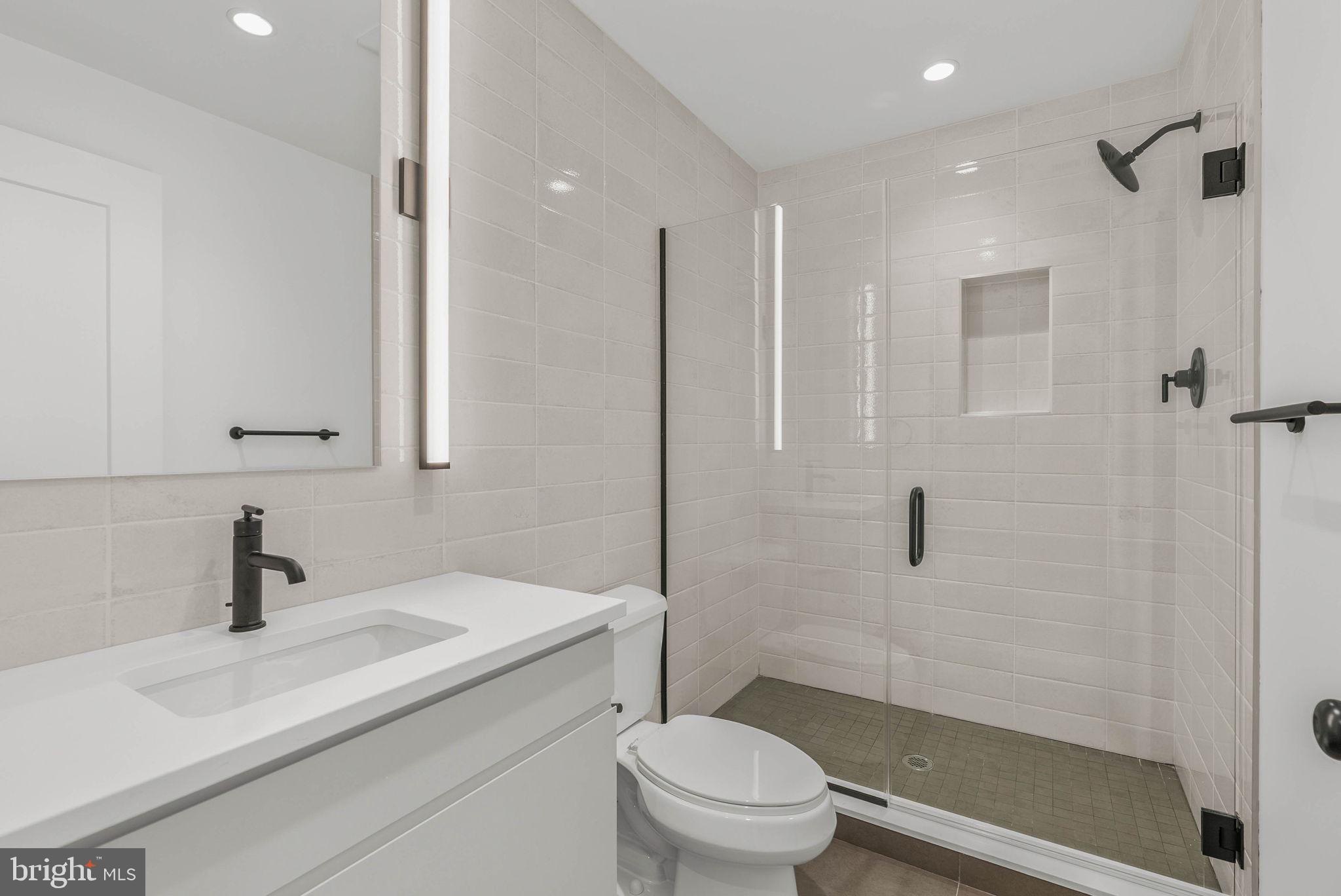 650 Fairmount Avenue, Unit A2 Philadelphia, PA 19123 - Photo 27 of 40 a bathroom with a sink a toilet and shower