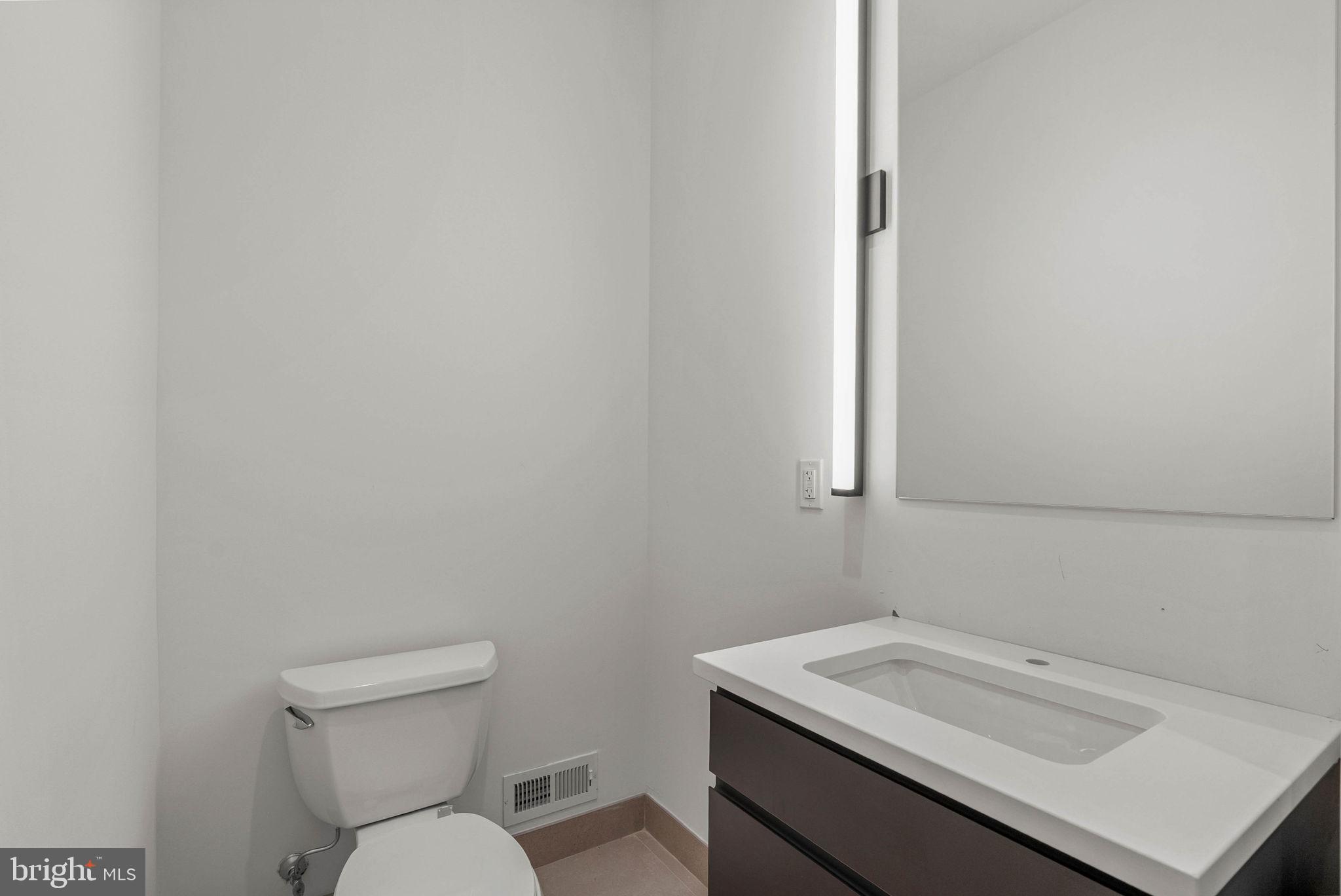 650 Fairmount Avenue, Unit A2 Philadelphia, PA 19123 - Photo 32 of 40 a bathroom with a sink toilet and vanity
