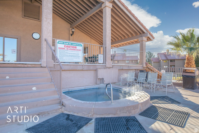 860 South Village Road, Unit A6 St. George, UT 84770 - Photo 17 of 41 View of swimming pool with grilling area, patio surround, and a hot tub