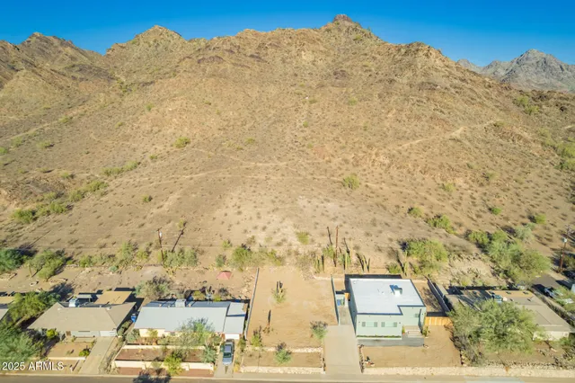 a view of a building with mountains in the background