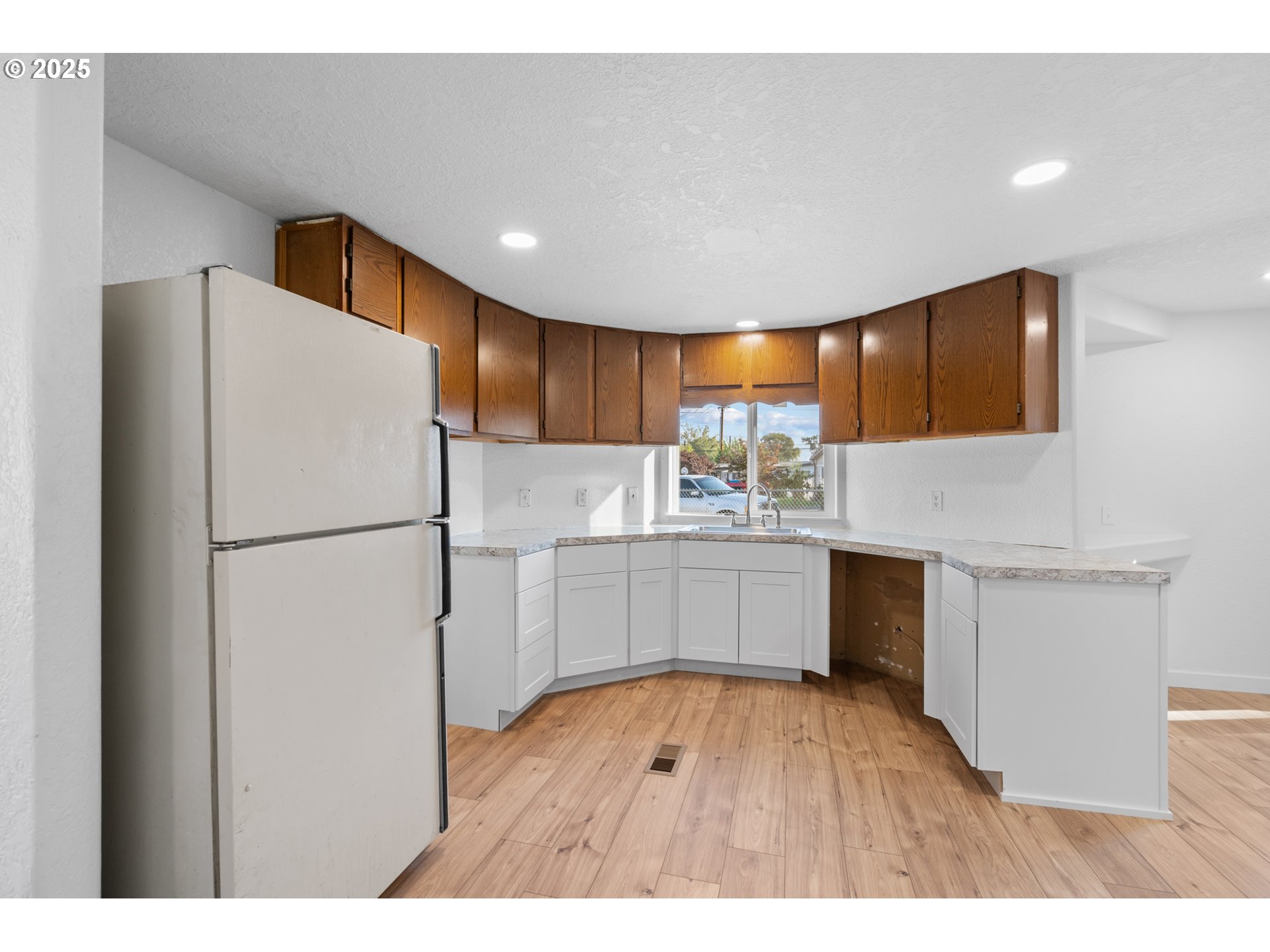 1175 Southwest Sandy Drive Hermiston, OR 97838 - Photo 11 of 30 a kitchen with a refrigerator sink and cabinets