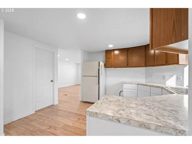 a kitchen with stainless steel appliances kitchen island a refrigerator sink and microwave