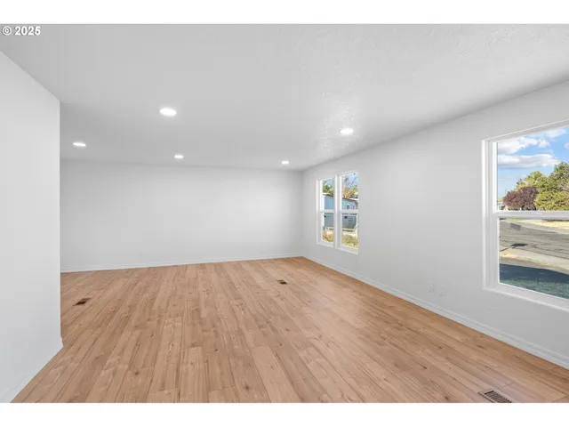a view of an empty room and wooden floor