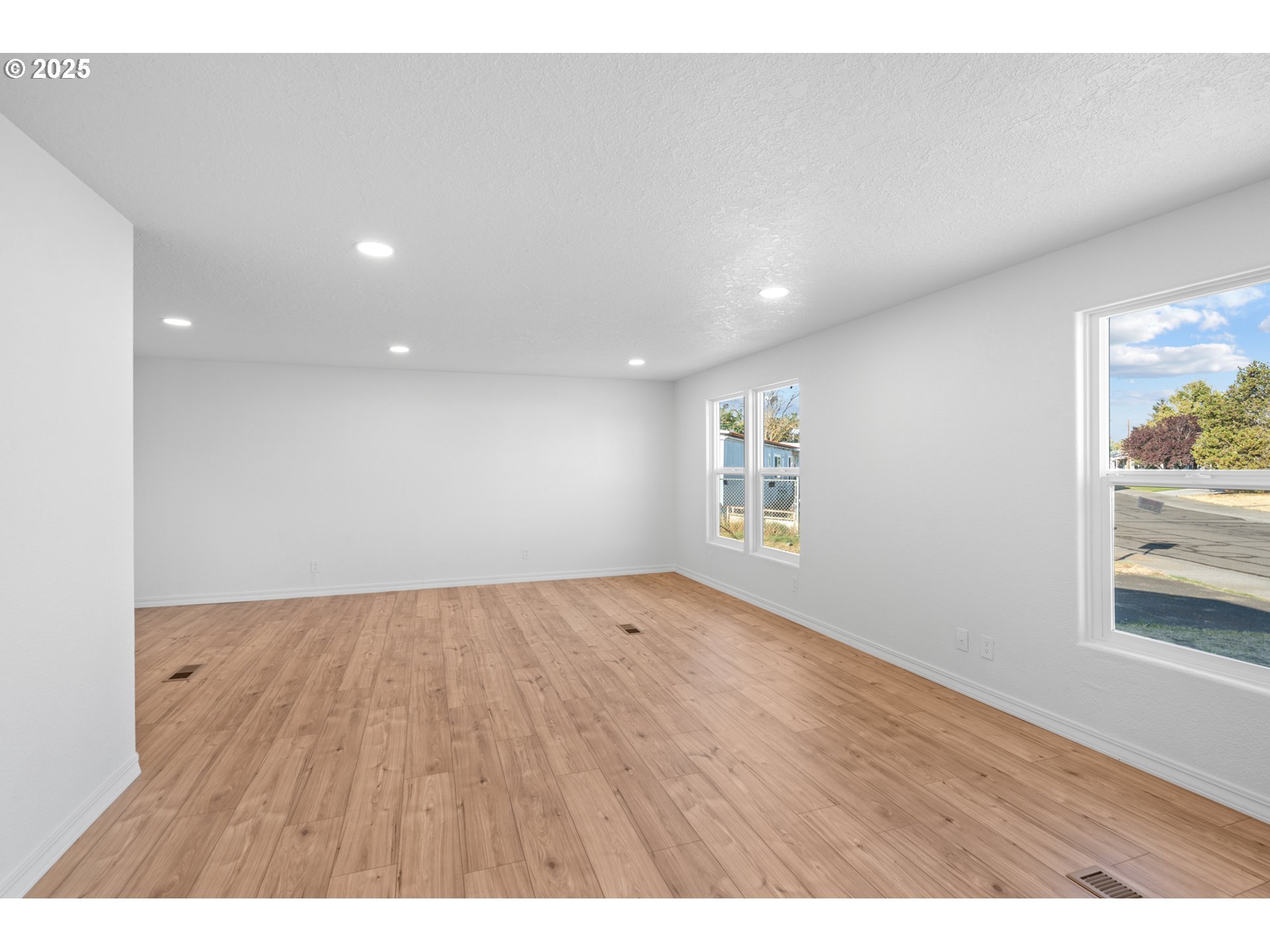 1175 Southwest Sandy Drive Hermiston, OR 97838 - Photo 19 of 30 a view of an empty room and wooden floor