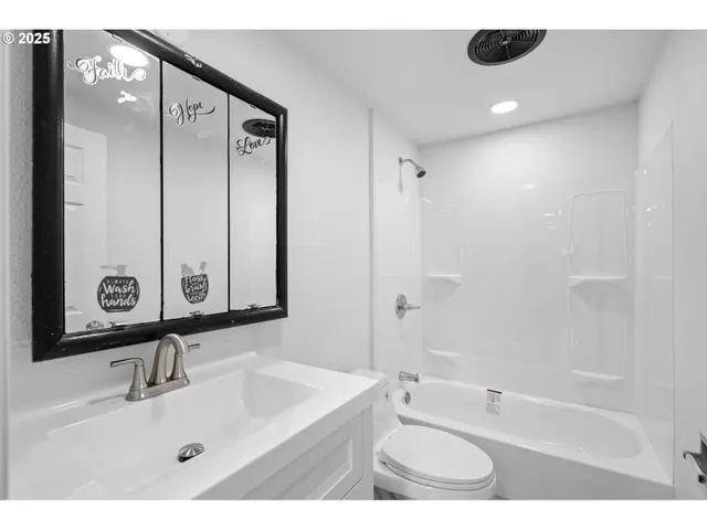 a bathroom with a tub sink and mirror
