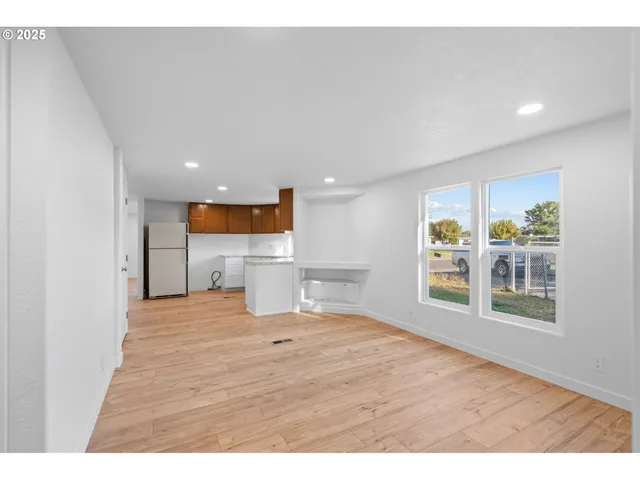 a view of a livingroom with wooden floor and a window