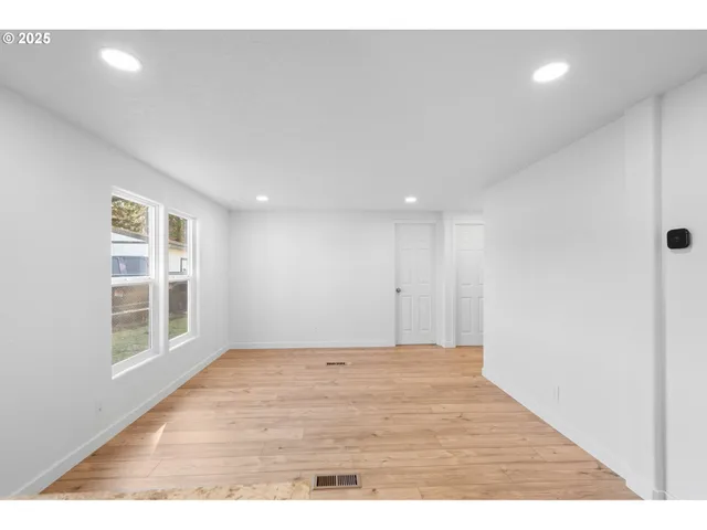 a view of an empty room with a window