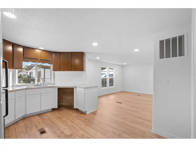 a kitchen with a refrigerator and a stove top oven