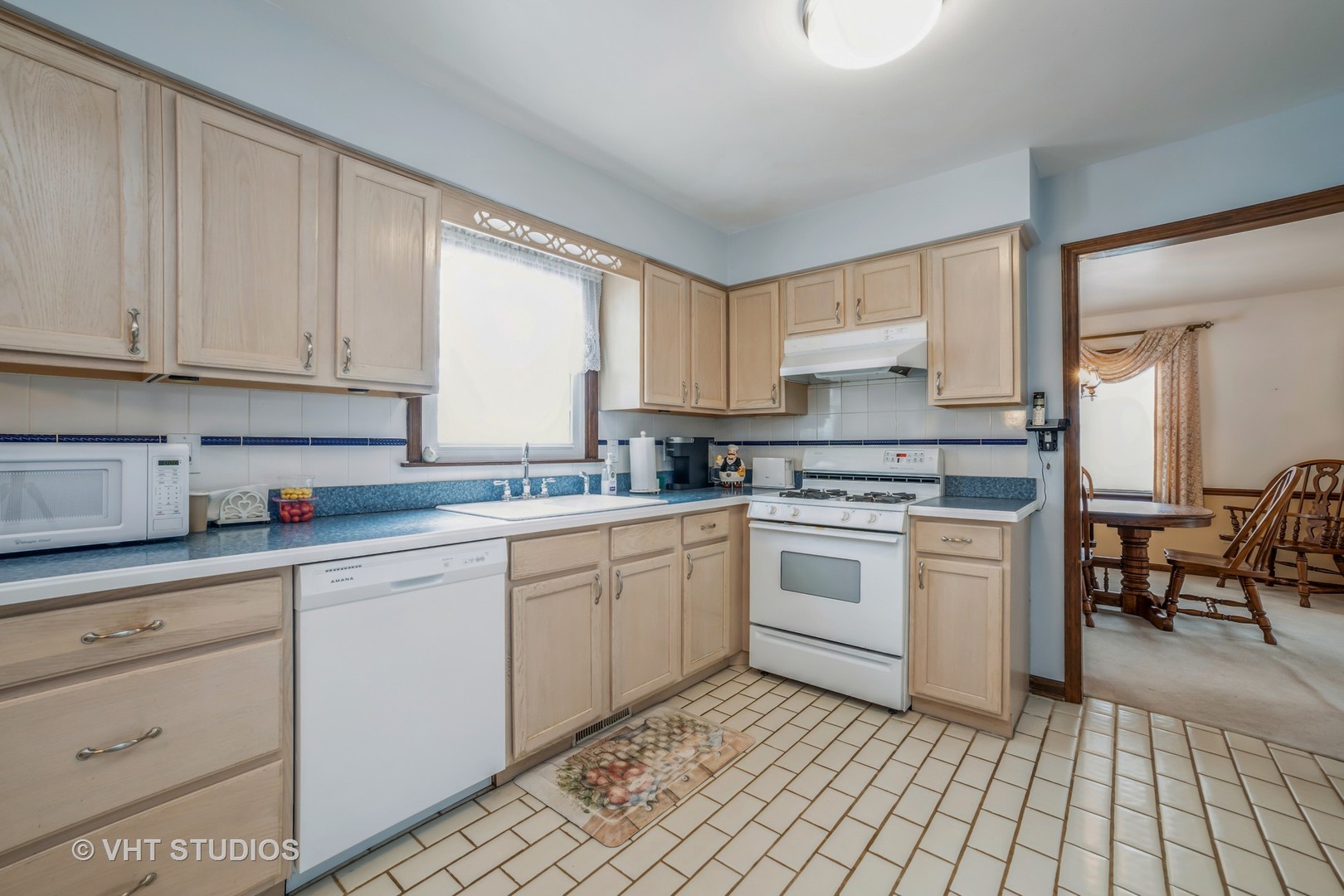 43-w043 Campton Hills Road Elburn, IL 60119 - Photo 7 of 22 a kitchen with a white cabinets and white appliances