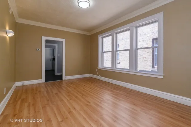 a kitchen with a stove and white cabinets