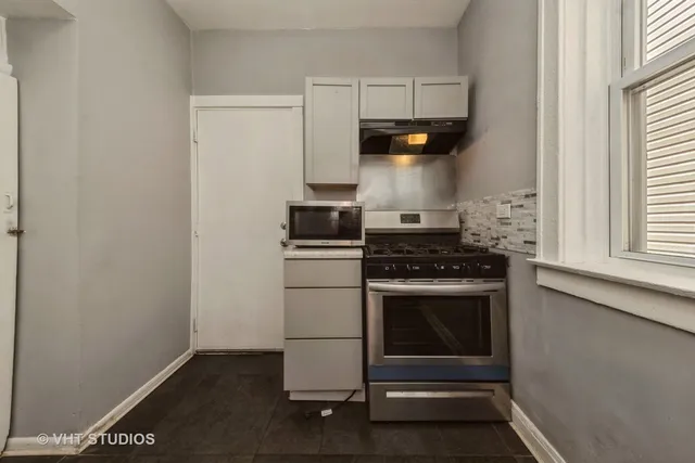a room with a sink and cabinets